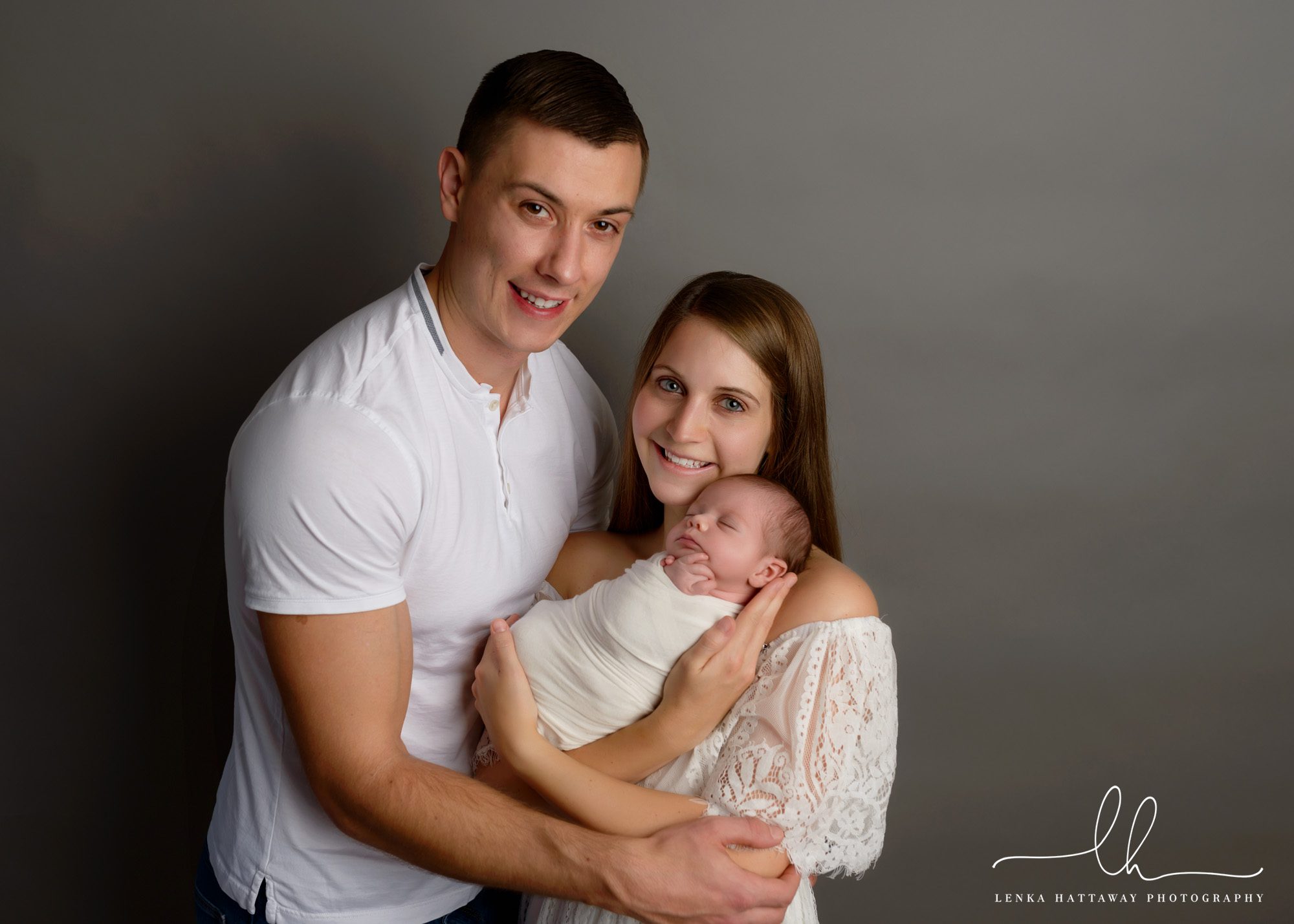 Baby with her parents during an in-home newborn session.