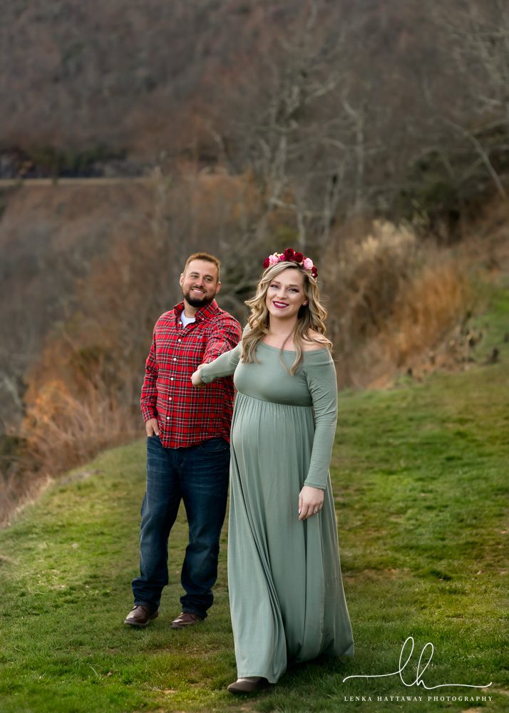 Expecting couple walking towards the camera during a maternity photo session.