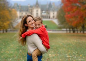 Son hugging his mom in a fall picture.