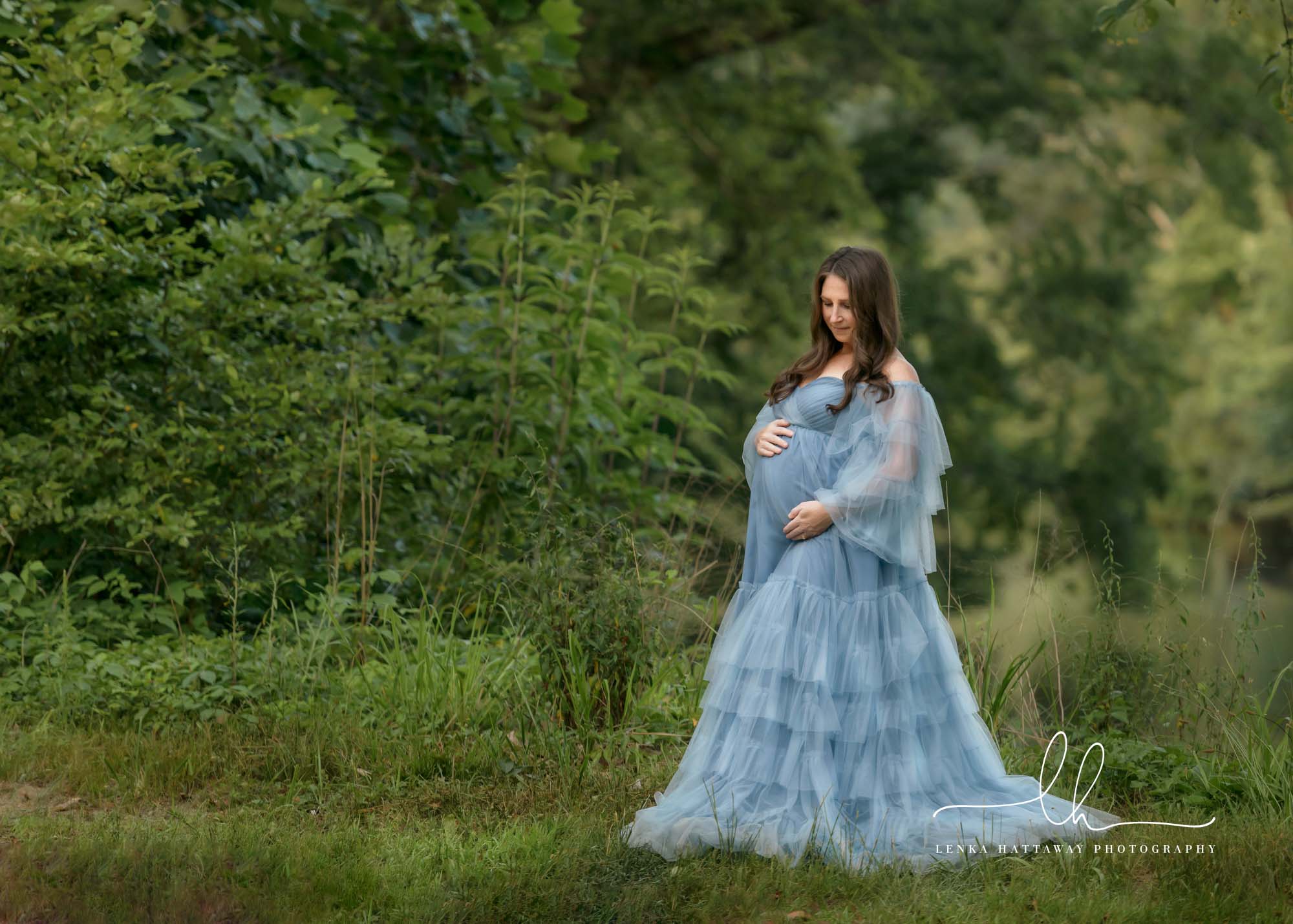 Mom-to-be in a blue dress during a maternity session.